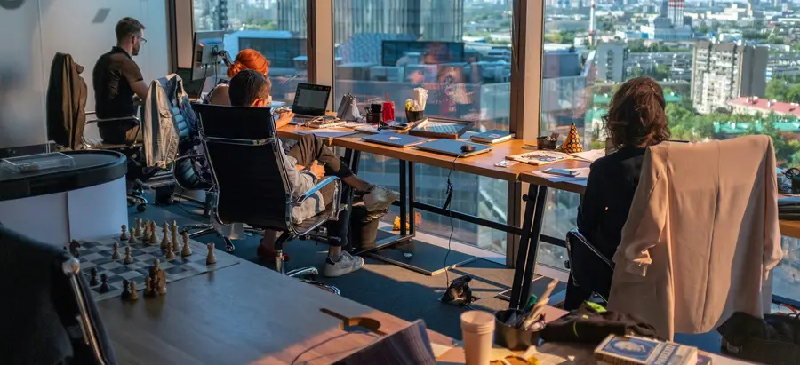 Team working at desks in a high-rise office overlooking the city
