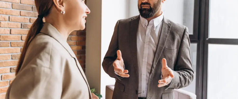 Two colleagues in conversation in a bright office