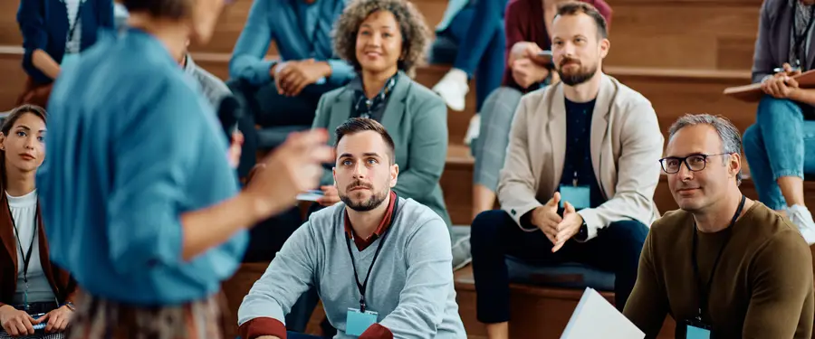 Business owners seated in a group listening to a speaker