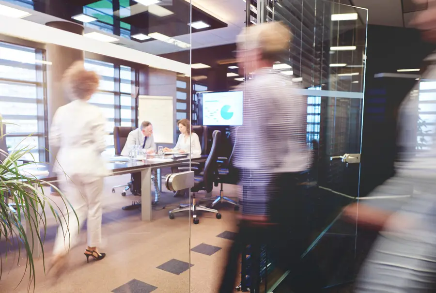 Team walking through a glass-walled office